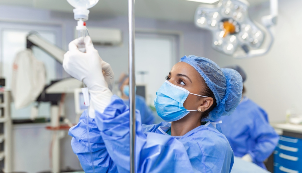 Doctor in the operating room putting drugs through an IV - surgery concepts